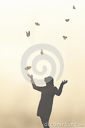 Romantic scene of a meeting between a woman and colorful butterflies Stock Photo