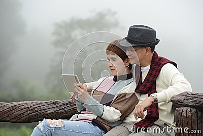 Romantic senior couples using digital tablet Stock Photo