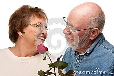 Romantic Senior Husband Giving Red Rose to Wife Stock Photo