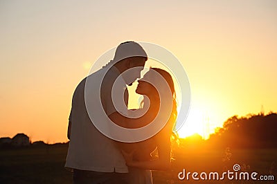 Romantic sensual young couple in love posing in field at the sun Stock Photo