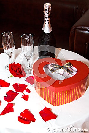 Romantic set - Champagne bottle with waterdrops with red box and two glasses Stock Photo
