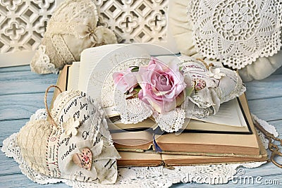 Romantic style arrangement with old books and handicraft textile hearts on the table Stock Photo