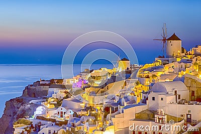 Romantic Sunset at Santorini Island in Greece. Image Taken in Oia Village At Dusk. Amazing Sunset with White Houses and Windmills Editorial Stock Photo