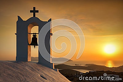 Romantic sunset seen from an old white orthodox church in Cyclades islands Stock Photo