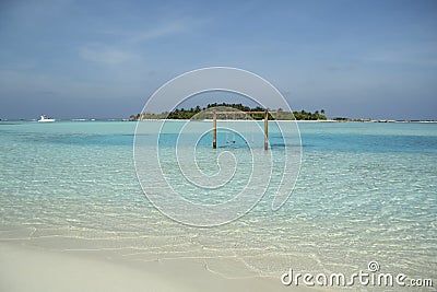 Romantic swing straight into the turquise ocean Stock Photo