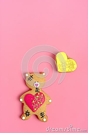 Romantic Teddy bear, gingerbread heart on trendy pink background. Stock Photo