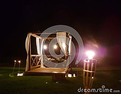 Romantic terrace with torches in a field Stock Photo