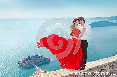 Romantic young couple in love over blue sea shore background. Fa Stock Photo