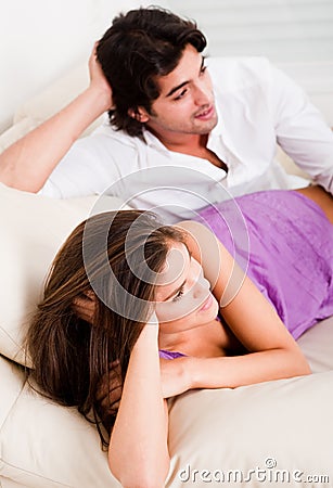 Romantic young couple lying in couch Stock Photo