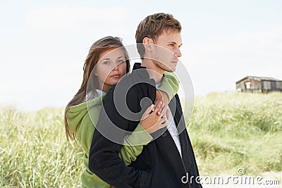 Romantic Young Couple Standing By Dunes Stock Photo