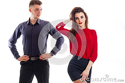 Romantic young girl in a red blouse and with lipstick on lips stands near high guy who looks at her Stock Photo