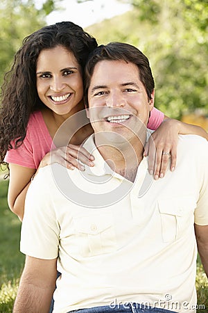 Romantic Young Hispanic Couple Relaxing In Park Stock Photo