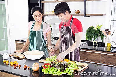 Romantic young lovely couple cooking food in the kitchen Stock Photo
