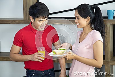 Romantic Young lovely couple show sandwich in the kitchen Stock Photo