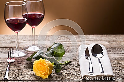 Romantically laid table with yellow roses and wine, romantic atmosphere Stock Photo