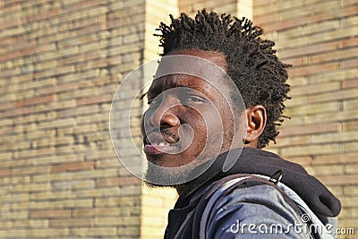 Rome, Italy - APRIL 10, 2018 : Portrait of a serious young unknown African American man. A man is walking along the street in the Editorial Stock Photo