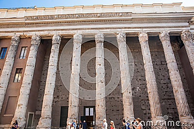 Tourists and locals at the surviving side colonnade of the Temple of Hadrian Editorial Stock Photo