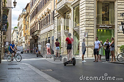 People on Segways ride along a street in the center of Rome Editorial Stock Photo