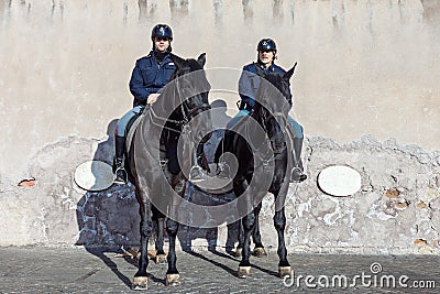 Mounted police officers patrolling street on black horses in Rome Editorial Stock Photo