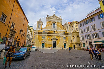 ROME, ITALY - JUNE 13, 2015: Little church at the end of the street in the middle of square, facade in yellow. Editorial Stock Photo