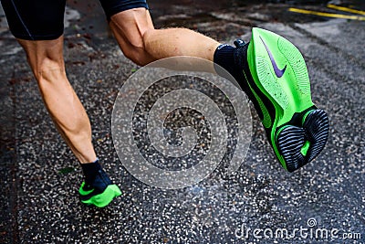 ROME, ITALY, JUNE 23. 2020: Nike running shoes ALPHAFLY NEXT%. Controversial green athletics shoe on legs of professional athlete Editorial Stock Photo