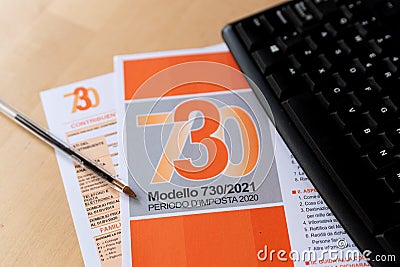 Rome, Italy - 2 march 2021: close up of modello 730 tax declaration income form, symbol of italian taxes and economy, with pen and Editorial Stock Photo