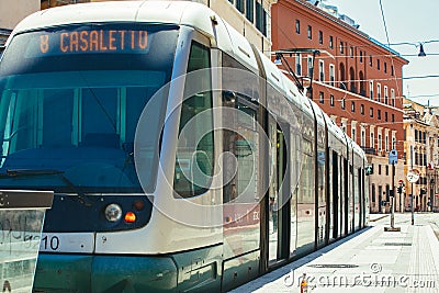 Electric tram for public transport in the historic center of Rome in Italy. Perspective in the outdoor Editorial Stock Photo