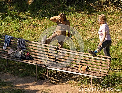 Group of masked and unmasked elderly people doing gymnastics on a lawn in Rome during self-isolation Editorial Stock Photo