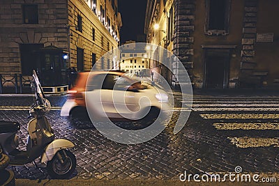 Vespa bike and passing cars in Rome Editorial Stock Photo
