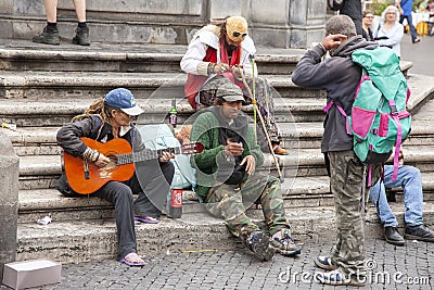 Rome, Italy, October 10, 2011: Homeless play the guitar on the steps of a Catholic temple Editorial Stock Photo