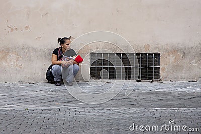 Rome, Italy, October 13, 2011: A homeless woman with a baby asks for alms Editorial Stock Photo