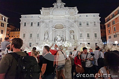 ROME, ITALY - September 12, 2016: Crowds of tourists visiting and posing in the front of the Trevi fountain on evening. Editorial Stock Photo