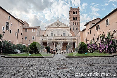 Rome, Italy, Tourists relax on the parapet of the fountain in the courtyard of the basilica Editorial Stock Photo