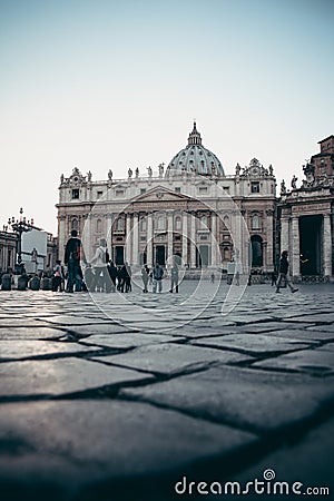 Tourists stroll around the square in front of St. Peter`s in the Editorial Stock Photo