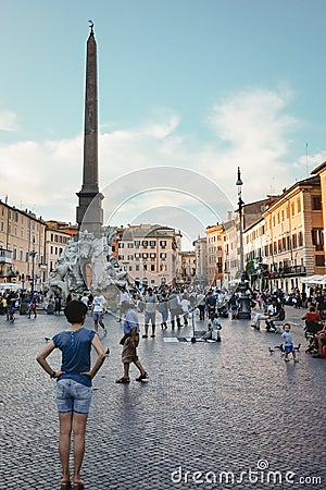 Rome, Italy - Woman standing in crowded Piazza Navona, public open space famous for Fountain of Four Rivers. Editorial Stock Photo