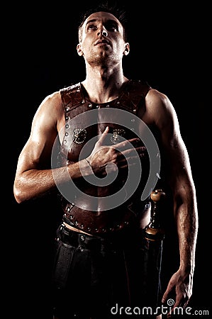 Rome warrior swearing on the black background Stock Photo
