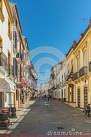 Ronda, Andalusia, Spain. tourists pass to the New Roman Bridge along a shopping street Editorial Stock Photo