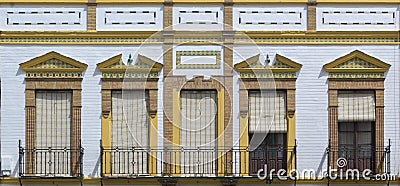 Front view of typical and classic building and windows with blinds and tiles in Ronda Editorial Stock Photo