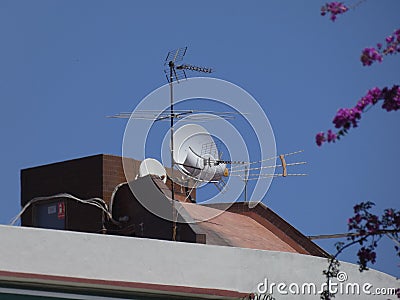 Antennas of communications on the roof over blue sky Stock Photo