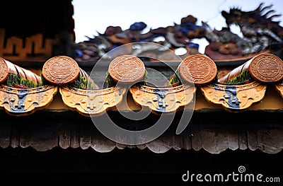 Roof decorations in the Forbidden Citadel in Hue during a rainy day, Vietnam Stock Photo