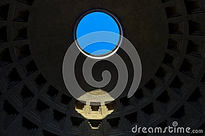 Roof of the dome of the pantheon in Rome seen from the inside with circular hole in the blue sky and light projected on top. Editorial Stock Photo