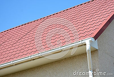 Roof gutter with house red metal tiled roof Stock Photo