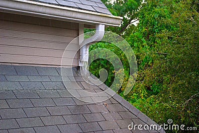 Roof gutter and runoff pipe on a rainy day Stock Photo