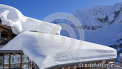 The roof of an house or hotel covered by massive quantity of fresh snow after heavy snowfall Stock Photo