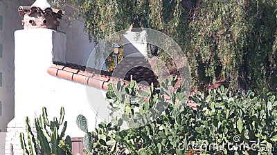 Roof of old mexican house tiled, ceramic clay tiles. Suburban California garden. Stock Photo