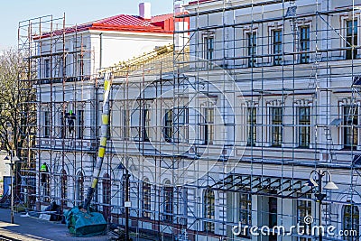 Roof repair of a historic building, restoration and painting of the facade Editorial Stock Photo