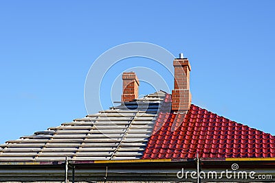 Roof replacement of a residential house, half replaced, half not yet Stock Photo