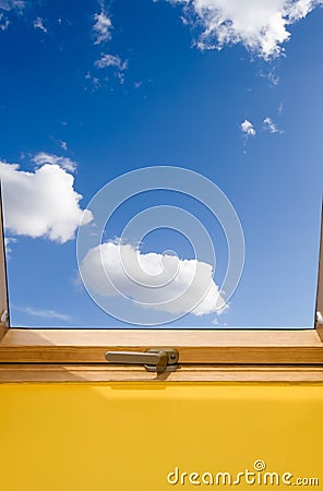 Roof skylight window and bue sky with white clouds Stock Photo