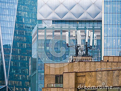 A roof top city view of mobile telecommunications masts and aerials. Stock Photo