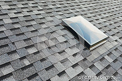 Roof window on shingles flat polymeric roof-tiles Stock Photo